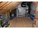 Spacious unfinished attic area showing rafters and storage of appliances and other household items at 4305 Albino Deer Way, Wake Forest, NC 27587