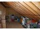 View of unfinished attic space showing exposed rafters and storage of household items at 4305 Albino Deer Way, Wake Forest, NC 27587