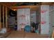 Unfinished attic space with exposed wooden framing with insulation and some stored household items at 4305 Albino Deer Way, Wake Forest, NC 27587