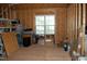 Unfinished attic space with window showing exposed wood framework ready for customization and storage at 4305 Albino Deer Way, Wake Forest, NC 27587