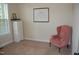 Bright bedroom with a tall dresser, a window with blinds, and a comfortable pink armchair at 4305 Albino Deer Way, Wake Forest, NC 27587
