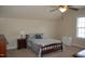 Cozy bedroom with ceiling fan, side table, and window at 4305 Albino Deer Way, Wake Forest, NC 27587