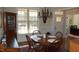 Formal dining room with a classic chandelier, wainscoting, and ample natural light at 4305 Albino Deer Way, Wake Forest, NC 27587