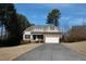 View of a single Gathering home with a well manicured lawn and driveway leading to a 2 car garage at 4305 Albino Deer Way, Wake Forest, NC 27587