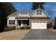 Charming single-Gathering home featuring stone and siding accents, a two-car garage, and a well-manicured lawn at 4305 Albino Deer Way, Wake Forest, NC 27587