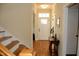 Welcoming foyer with hardwood floors, a staircase, and a stylish entryway table at 4305 Albino Deer Way, Wake Forest, NC 27587