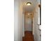 Bright hallway featuring hardwood floors, neutral walls, and classic white trim at 4305 Albino Deer Way, Wake Forest, NC 27587