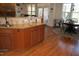Kitchen island with granite countertops, hardwood floors, and stainless steel sink at 4305 Albino Deer Way, Wake Forest, NC 27587
