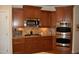 Gourmet kitchen with custom cabinetry, granite countertops, and modern stainless steel appliances at 4305 Albino Deer Way, Wake Forest, NC 27587