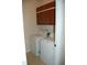 Functional laundry room with a washer, dryer, and overhead cabinets at 4305 Albino Deer Way, Wake Forest, NC 27587