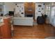 Bright living room featuring hardwood floors, a stone fireplace, and built-in bookshelves at 4305 Albino Deer Way, Wake Forest, NC 27587