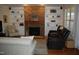 Cozy living room featuring a stone fireplace, built-in bookshelves, and comfortable seating at 4305 Albino Deer Way, Wake Forest, NC 27587