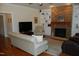 Inviting living room with a stone fireplace, hardwood floors, and a comfortable sofa at 4305 Albino Deer Way, Wake Forest, NC 27587