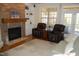 Cozy living room with a stone fireplace, hardwood floors, and comfortable seating at 4305 Albino Deer Way, Wake Forest, NC 27587