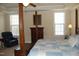 Well-lit main bedroom features a four-poster bed, dresser, and reading chair at 4305 Albino Deer Way, Wake Forest, NC 27587
