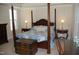 Spacious main bedroom with four-poster bed, side tables, and trunk at 4305 Albino Deer Way, Wake Forest, NC 27587