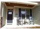 Cozy front porch with rocking chairs, showcasing the entrance and inviting curb appeal at 4305 Albino Deer Way, Wake Forest, NC 27587