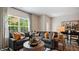Cozy living room featuring a large sofa, accent pillows, and stylish decor at 452 Belgian Red Way, Wake Forest, NC 27587