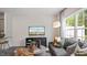 Comfortable living room with large windows, a modern sofa, and stylish decor create a relaxing atmosphere at 461 Belgian Red Way, Wake Forest, NC 27587
