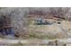An elevated shot highlights the home's pond, driveway, and its serene wooded surroundings at 466 Oren Gaines Rd, Goldston, NC 27252