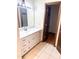 Bright bathroom with a white vanity, marble countertop, and an adjacent doorway at 466 Oren Gaines Rd, Goldston, NC 27252