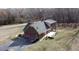 Exterior view featuring a two-car garage, a rear deck, and mature trees at 466 Oren Gaines Rd, Goldston, NC 27252