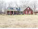 Charming brick home featuring a welcoming front porch and bright red shutters at 466 Oren Gaines Rd, Goldston, NC 27252