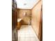 Functional laundry room with tile flooring, washer/dryer hookups, and built-in shelving at 466 Oren Gaines Rd, Goldston, NC 27252