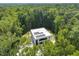 Aerial view of modern home surrounded by lush greenery, showcasing its private location at 4908 Birchleaf Dr, Raleigh, NC 27606