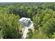 Aerial view of modern home surrounded by lush greenery, showcasing its private location at 4908 Birchleaf Dr, Raleigh, NC 27606
