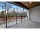 Spacious balcony offering black metal railings and panoramic views of the surrounding tree line at 4908 Birchleaf Dr, Raleigh, NC 27606