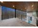 Expansive balcony showcasing sleek metal railings and a wood-paneled ceiling overlooking a sparkling swimming pool and lush greenery at 4908 Birchleaf Dr, Raleigh, NC 27606