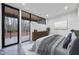 Modern bedroom boasts natural light from the sliding glass doors which provide direct access to the outdoor balcony at 4908 Birchleaf Dr, Raleigh, NC 27606