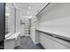Walk-in closet boasts built-in shelving, drawers, and hanging rods for ample storage at 4908 Birchleaf Dr, Raleigh, NC 27606
