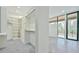 Walk-in closet with built-in shelves, and concrete floors, adjacent to a bedroom with outdoor balcony access at 4908 Birchleaf Dr, Raleigh, NC 27606