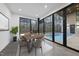 Modern dining room with a pool view, featuring a wooden table and comfortable chairs at 4908 Birchleaf Dr, Raleigh, NC 27606