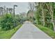 Long, private driveway leading to a secluded property, surrounded by lush greenery and trees at 4908 Birchleaf Dr, Raleigh, NC 27606