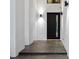 Modern home's entryway features a black front door, sleek lighting, and a clean aesthetic at 4908 Birchleaf Dr, Raleigh, NC 27606