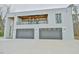 Contemporary home showcasing a balcony, wooden ceiling and gray garage doors at 4908 Birchleaf Dr, Raleigh, NC 27606