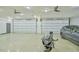 Oversized garage with car, motorcycle, and dual garage doors at 4908 Birchleaf Dr, Raleigh, NC 27606
