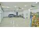Spacious, bright garage with sleek flooring, ceiling fans, and ample storage at 4908 Birchleaf Dr, Raleigh, NC 27606