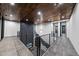 Second floor hallway with modern railings, a wood ceiling, recessed lighting, and doorway views to the exterior at 4908 Birchleaf Dr, Raleigh, NC 27606