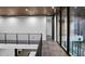 Hallway on upper floor with views through large windows, wood ceiling, and modern railings at 4908 Birchleaf Dr, Raleigh, NC 27606