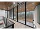 Hallway with a wall of floor to ceiling windows that allow for abundant natural light to shine through at 4908 Birchleaf Dr, Raleigh, NC 27606