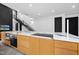 Kitchen boasts large island with oven and cooktop set in white countertops and light wood cabinetry at 4908 Birchleaf Dr, Raleigh, NC 27606