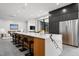 Bright kitchen features an expansive island with sleek white countertops, seating, and modern stainless appliances at 4908 Birchleaf Dr, Raleigh, NC 27606