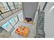 Aerial view of the living space, highlighted by a cozy sofa, TV, staircase and access to a pool and balcony at 4908 Birchleaf Dr, Raleigh, NC 27606
