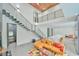 Bright living room with open staircase, modern decor and a view into the kitchen at 4908 Birchleaf Dr, Raleigh, NC 27606