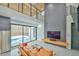 Open-concept living room features floor-to-ceiling windows with a pool view and comfortable leather furniture at 4908 Birchleaf Dr, Raleigh, NC 27606