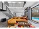 Open-concept living room with pool access features modern decor and an island with marble countertops at 4908 Birchleaf Dr, Raleigh, NC 27606